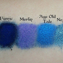 Eyeshadow swatches in blue, purple, and teal shades with text "Ferric", "Merlin", "Age Old Tale", and "Nej