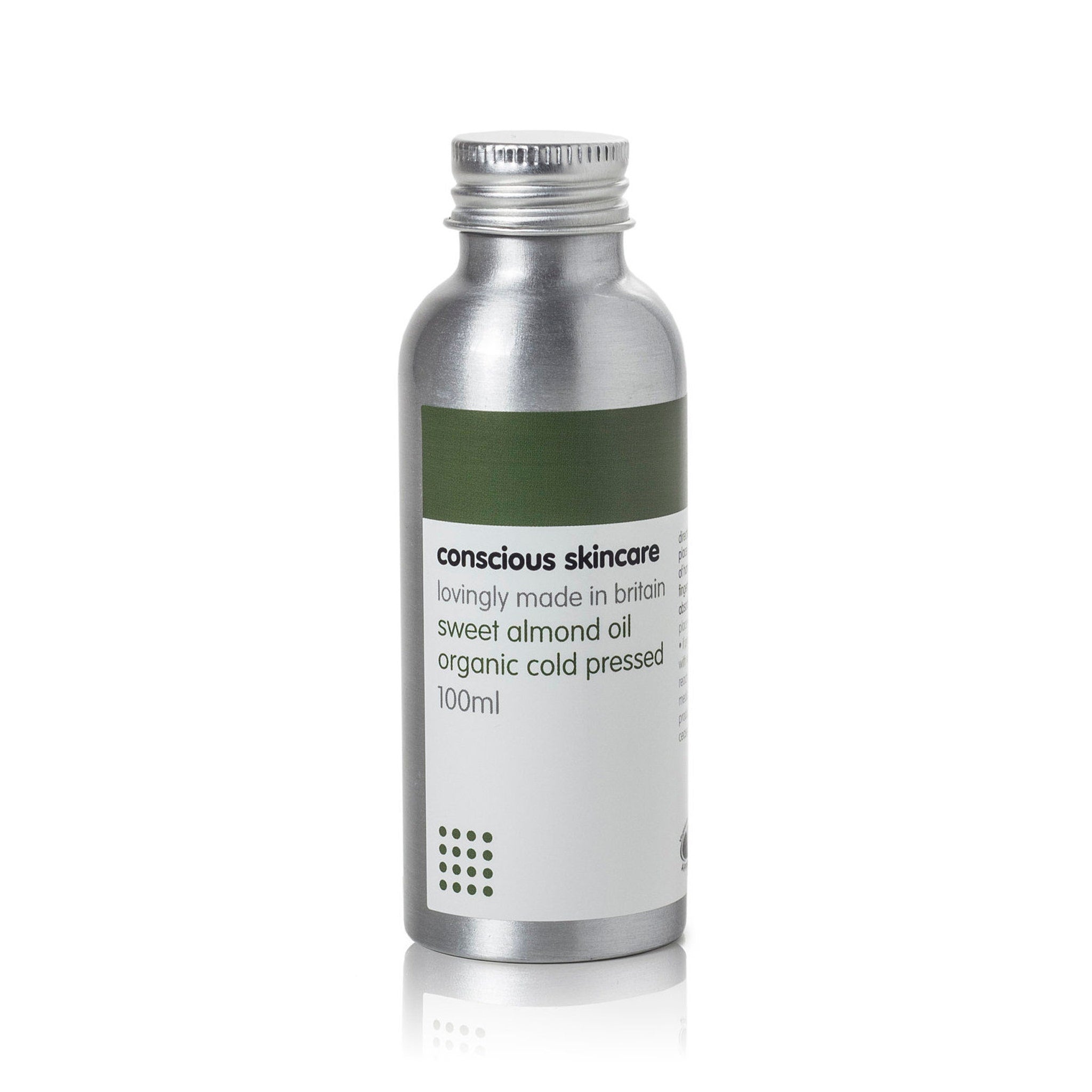 Organic Almond Oil bottle, silver metal, white label with text "conscious skincare