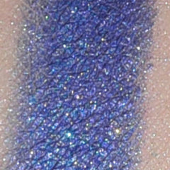 Side view of mineral eye shadow jar showing sifter top and UV protection label with pigmented powder visible