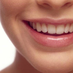 Smiling mouth with pink lips, white teeth, and smooth skin close-up