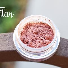 Small round jar of Titan pigmented mineral eye shadow with black sifter lid and metallic label