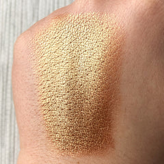 Close-up of Tala BR2 copper eye shadow pigment showing rich metallic shimmer in compact jar