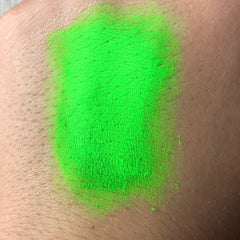 Neon green swatch on skin, showing texture and color gradient