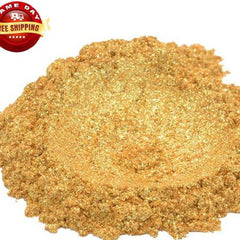 Close-up of vibrant 24K gold mica powder in a clear jar with black screw-top lid, showcasing shimmering yellow pigment.