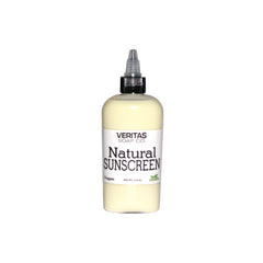 Natural sunscreen bottle with white label, black cap, and light yellow liquid inside
