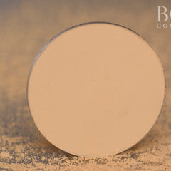 Side view of matte yellow eyeshadow single pan in compact with product name visible on label