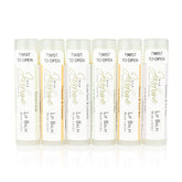 Lip balm tubes with white, gold, and colored labels, Wild Jasmine brand, for lip care