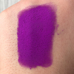 Close-up of vibrant purple Tala Neon Pigments loose eye shadow with intense shimmer finish