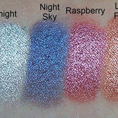 Eyeshadow swatches, metallic Night Sky, Raspberry, and Light Peach colors on skin