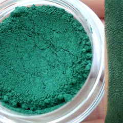 Single matte green eyeshadow pan with smooth powder texture in sleek black compact