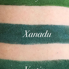 Close-up of matte green eyeshadow pan with smooth, velvety texture and rich pigment saturation