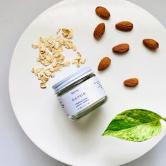 Cleansing grains jar with white label, brown almonds, and green leaf on white plate