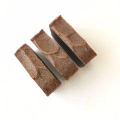 Soap bars brown with textured surface and dark edges, arranged on white background