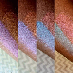 Swatches of iridescent pink, blue, and gold shimmer on skin, showing color variations