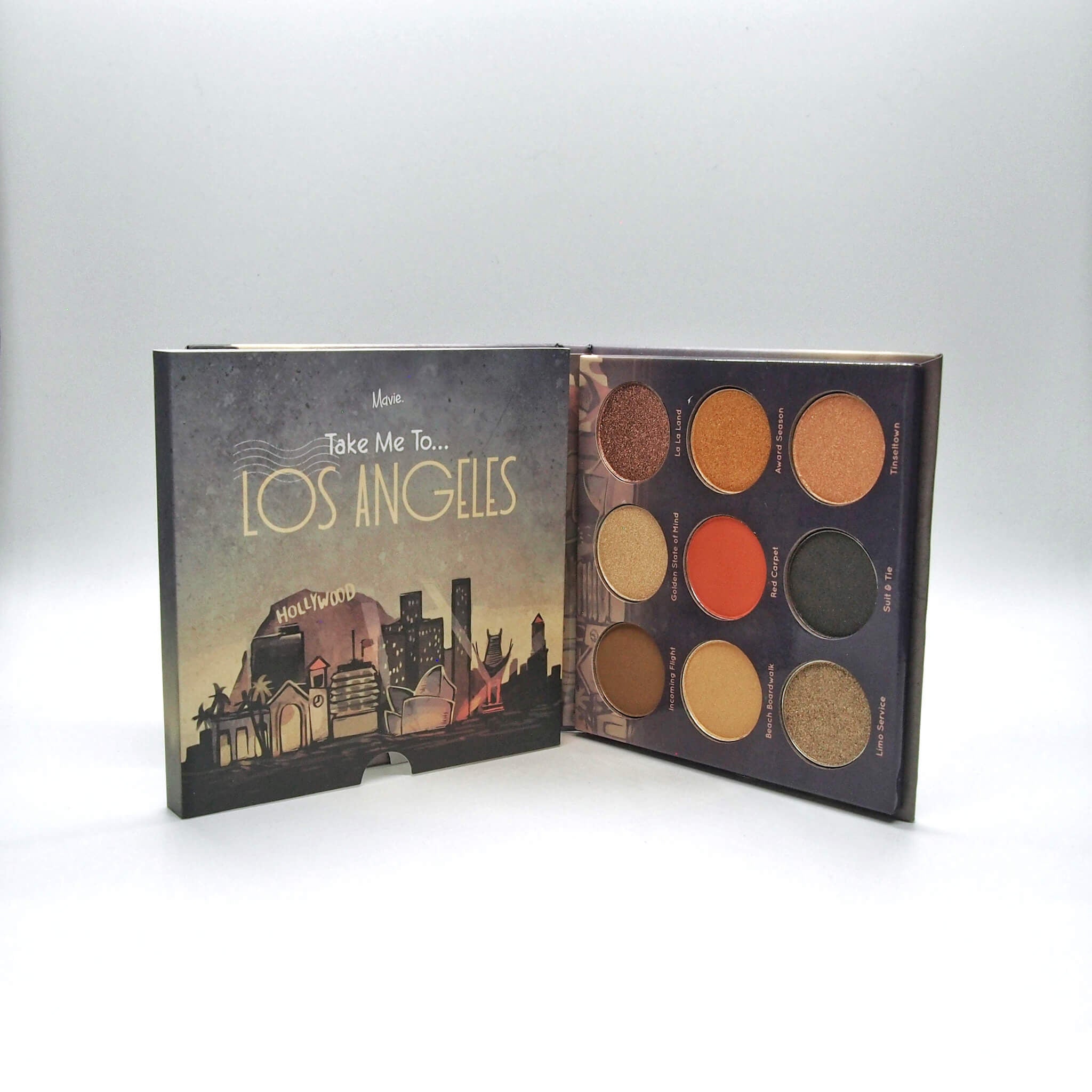 Eyeshadow palette with multiple colors, brand name Mavie, and Los Angeles design on the cover
