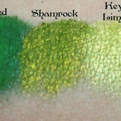 Green eyeshadow swatches with green, yellow, and shimmer textures on skin sample