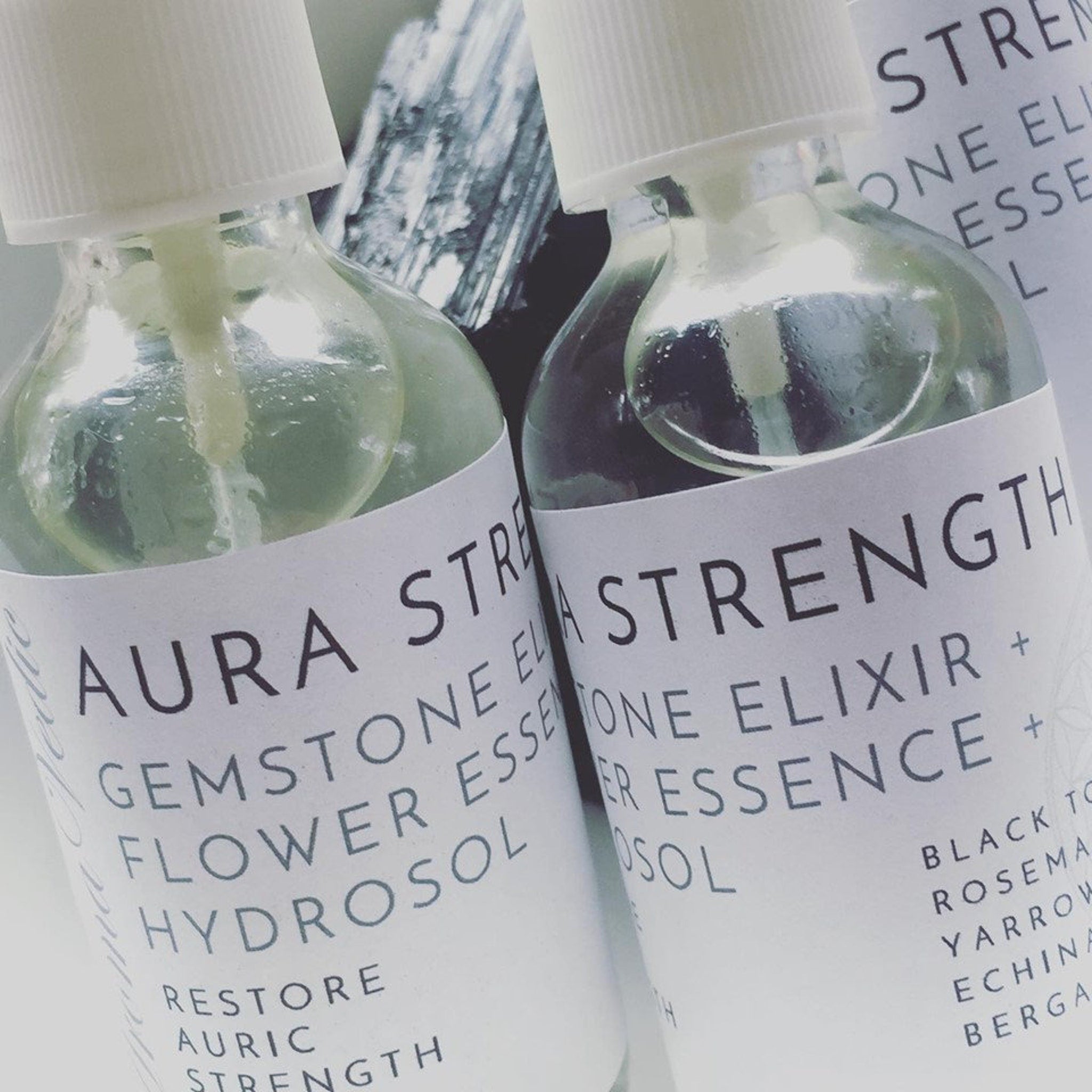 Toner bottles, clear glass with white labels, Crystal Vaults Aura Strength product