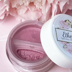 Pink eyeshadow in clear jar with white lid and floral design, Ethe brand visible