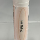 Lip balm tube with beige and white paper, brand name Bee Naked in black text