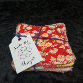 Reusable face wipes, red floral print, with Anita Rose Designs tag, tied with purple twine