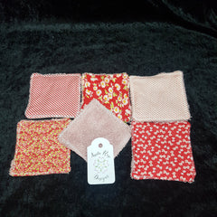 Washcloths in red floral, bow, and geometric patterns, with Anita Rose Designs tag visible