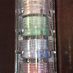 Mineral eyeshadow stack with clear plastic container, multiple colors, and layered design