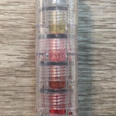 Stack of five jewel-toned mineral eye shadows with glitter finish in a sleek black compact