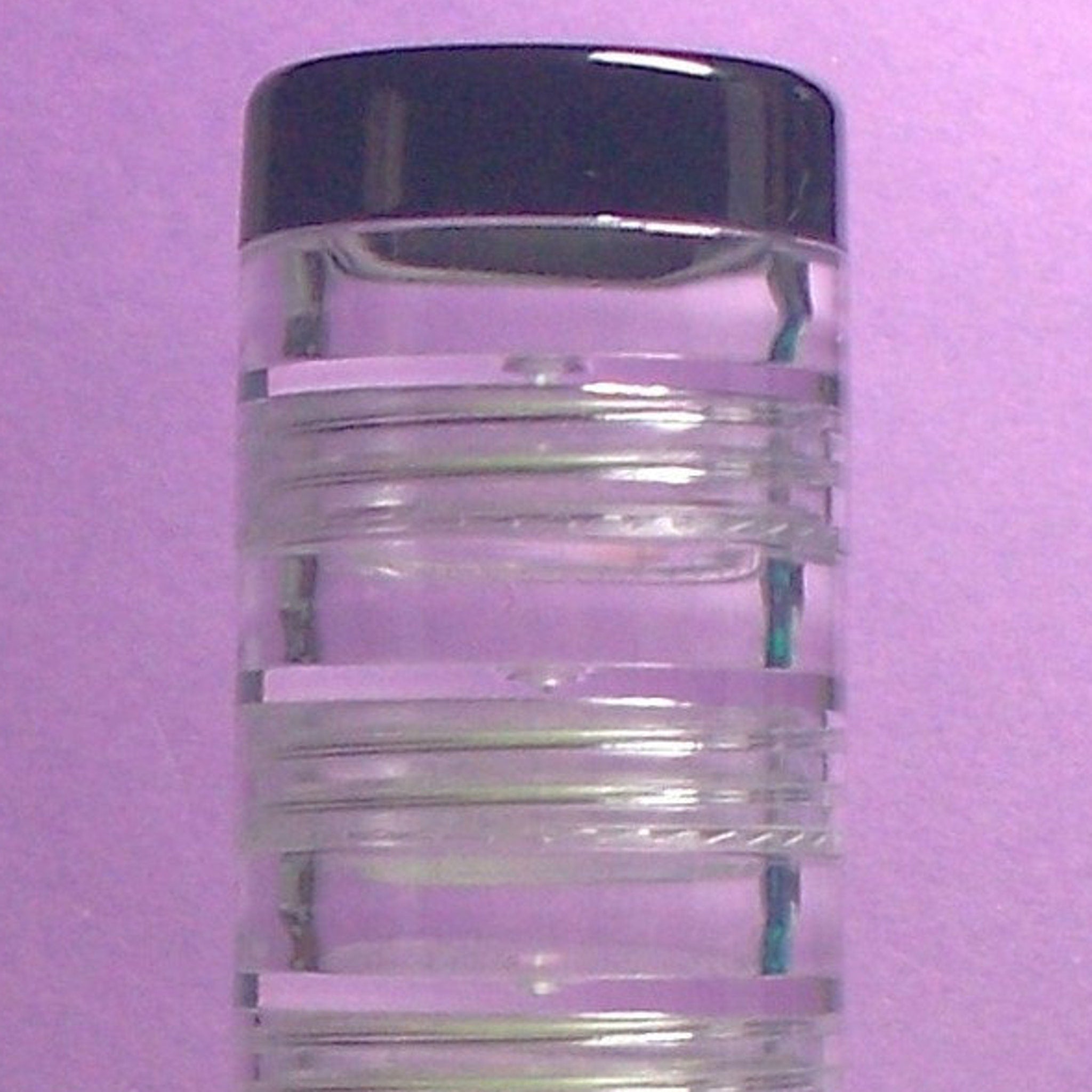 Stack of 10 round 5g eyeshadow jars with clear lids showing assorted matte and shimmer powder colors