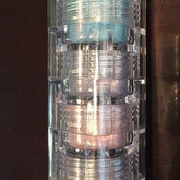 Mineral eyeshadow stack with blue, silver, and pink shades in clear plastic container