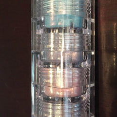 Mineral eyeshadow stack with blue, silver, and pink shades in clear plastic container