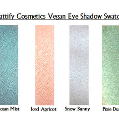 Close-up of holographic white eye shadow with sparkling fairy shimmer in compact palette