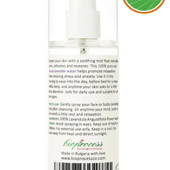 Lavender water spray bottle, clear glass, white pump top, bioprocess label visible
