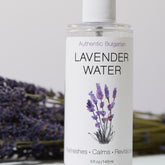 Toner bottle with lavender illustration, clear glass, white label, and purple text