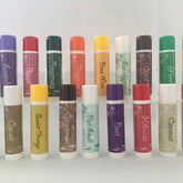 Lip balms, colorful tubes with white text labels, various flavors and scents of Forest Hills Remedies