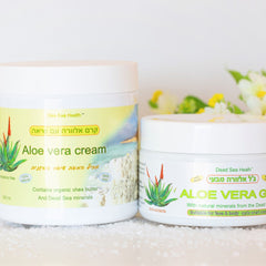 Aloe vera cream jars, white plastic containers with green and yellow labels, Dead Sea Health brand visible