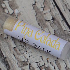 Lip balm tube with white label, yellow text, and clear plastic casing