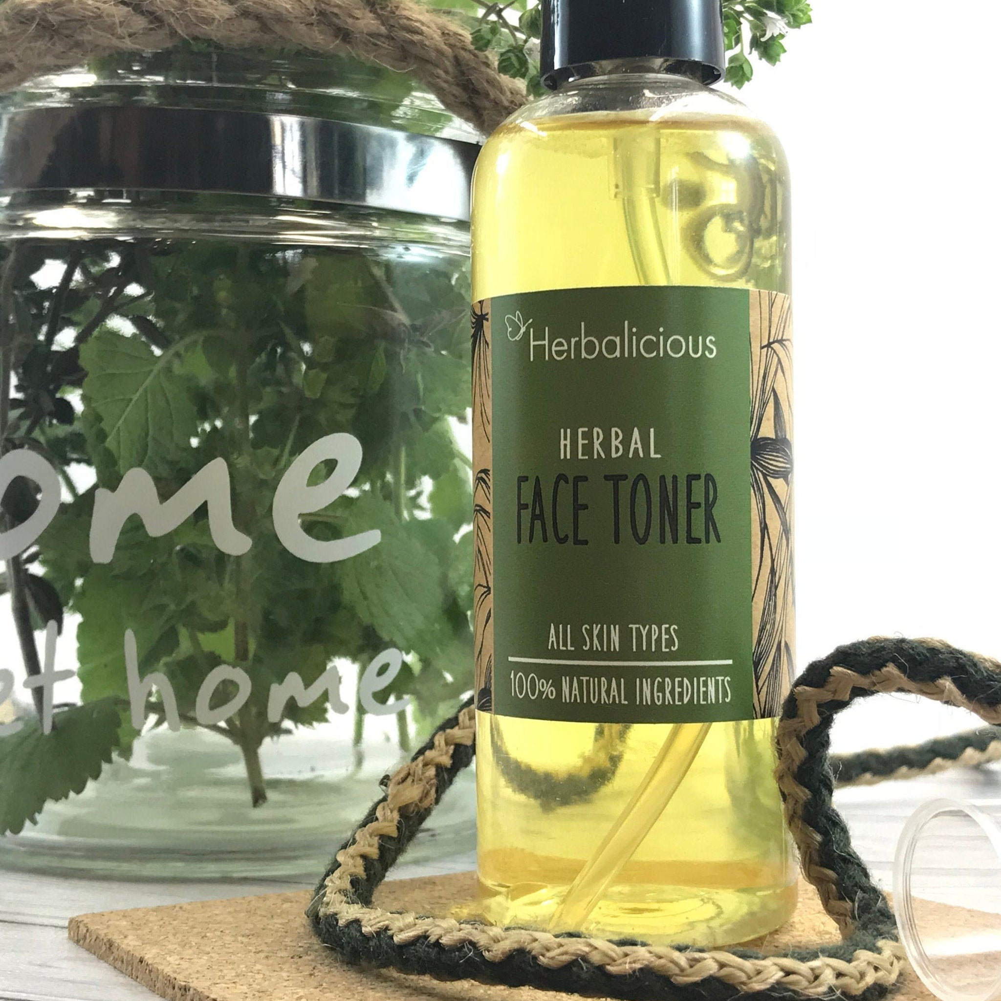 Face toner bottle with yellow liquid, green label, and myHerbalicious branding, on a wooden surface