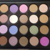 Open 28-color eyeshadow palette displaying matte and shimmer shades in warm neutrals and bold jewel tones