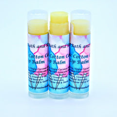 Lip balm tubes with yellow balm, patterned blue and pink label, and brand text