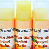 Lip balms with yellow balm, orange and white label, "Ancient Bath and Body" text visible