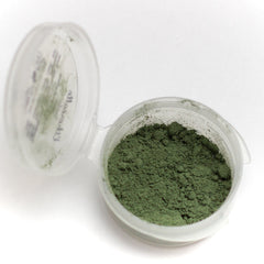 Side view of matte khaki green mineral eyeshadow pan with vegan makeup label visible