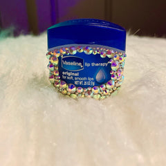 Lip therapy Vaseline jar, blue lid, iridescent gem border, on white fluffy surface