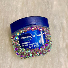 Lip balm with blue container, iridescent rhinestones, and Vaseline branding