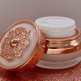 Eye makeup creme jar, rose gold and white, ornate lid details, open to show product