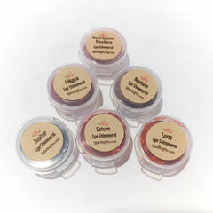 Eye shimmer pots with various colors, clear plastic containers, and tan labels with text