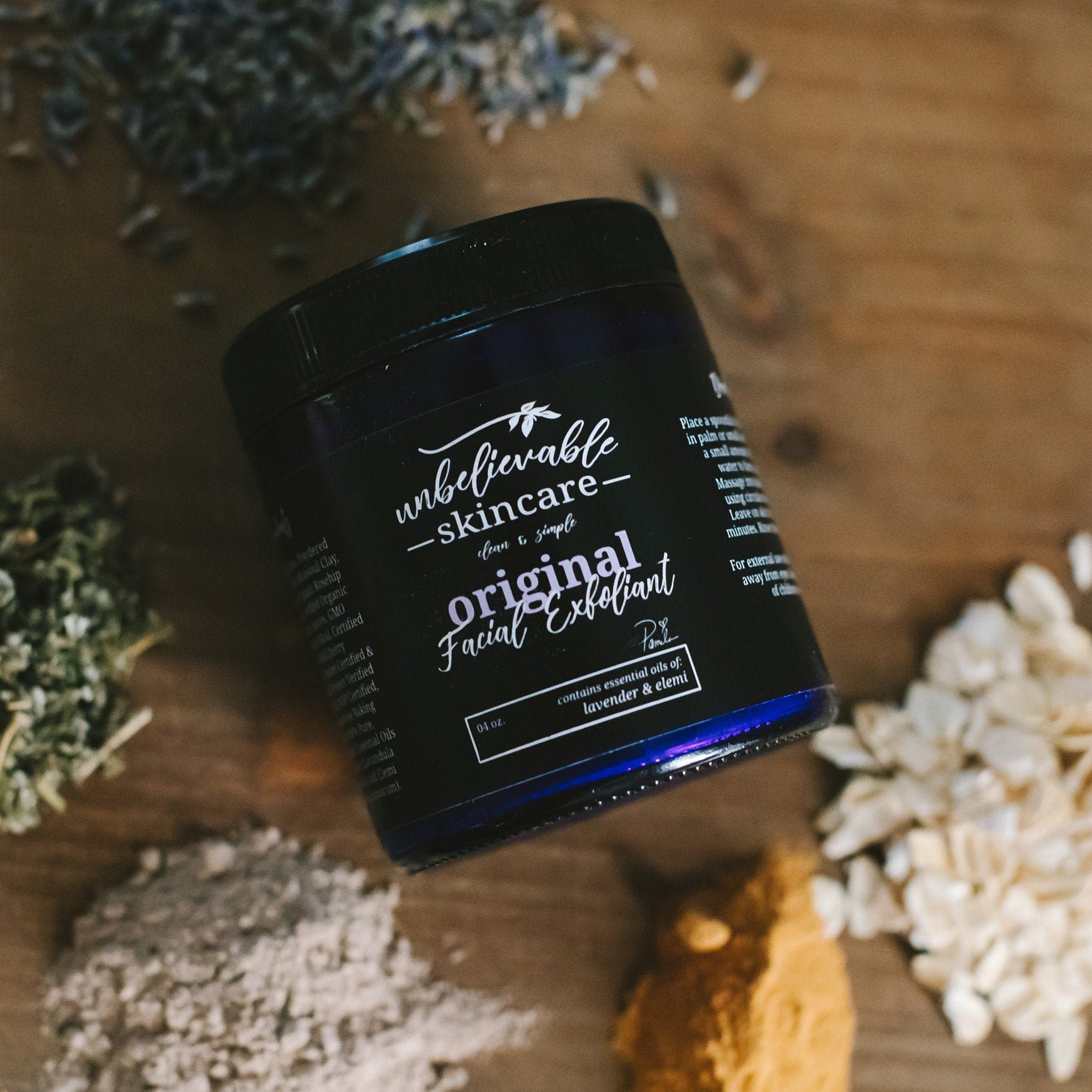 Facial Cleanser jar, black glass, white text "original Facial Exfoliant" on label, surrounded by ingredients