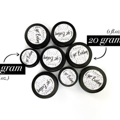 Eye balm tins, black metal containers with white labels, KaromniCo branding visible, coffee infused product