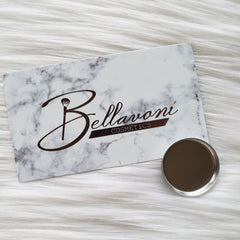 Bellavoni Cosmetics card with marble pattern and brand logo, with a metallic compact on a white fur background