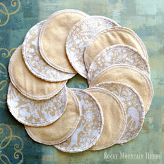 Reusable nursing pads, beige fabric with white floral pattern and white stitching, Rocky Mountain Herbs