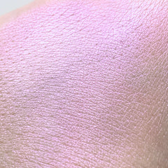 Pink iridescent skin texture with visible pores and lines